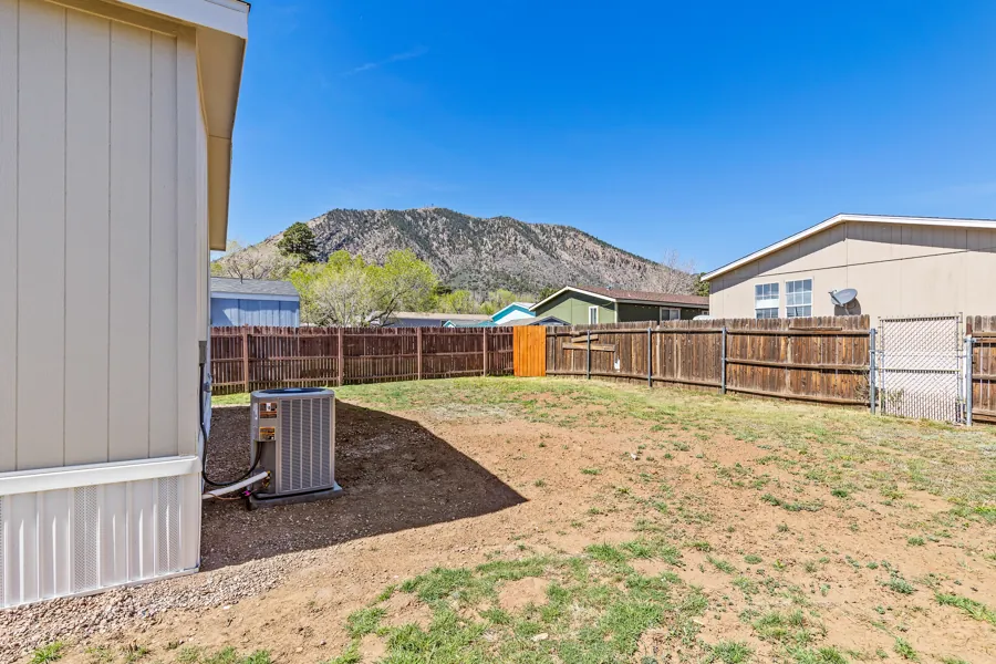 Fully fenced backyard with a view of Mt. Elden