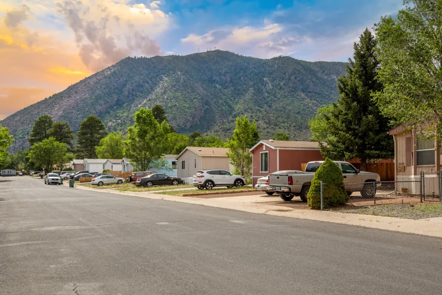 A Jo Don street with homes, driveways, and Mt. Elden in the background