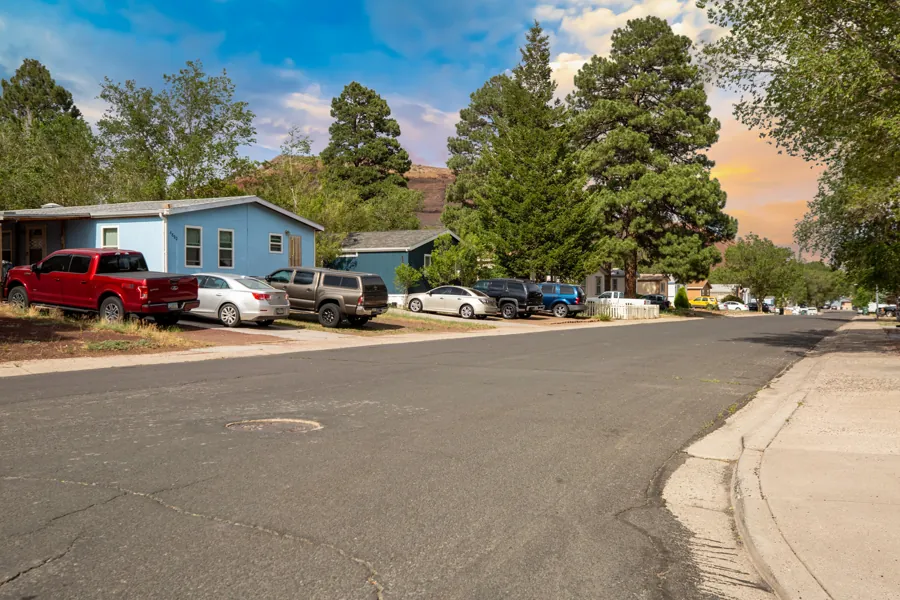 Wide, city-maintained Jo Don street with sidewalks and homes