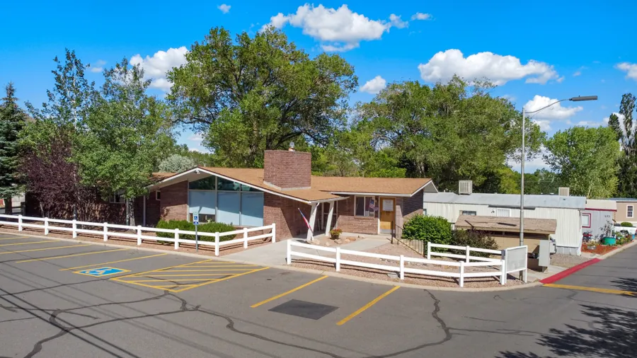 The Colony and Jo Don community office, a brick building with a white fence
